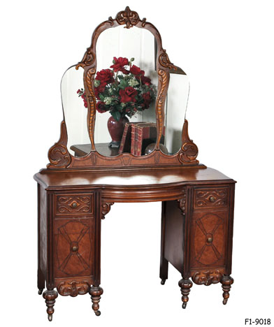 VANITY TABLE: with Mirror, 1920's Tradtitional, Walnut with Molded Scroll Decorations & Incised Tracery, Three Serpentine Glass Pieces Applied to Scalloped Arch Back with Scroll & Gadrooned Moldings, Double Pedestal Base with 4 Drawers-Each with Knobs, 8 Short Baluster Legs, 44 x 19 x 69-1/4"H